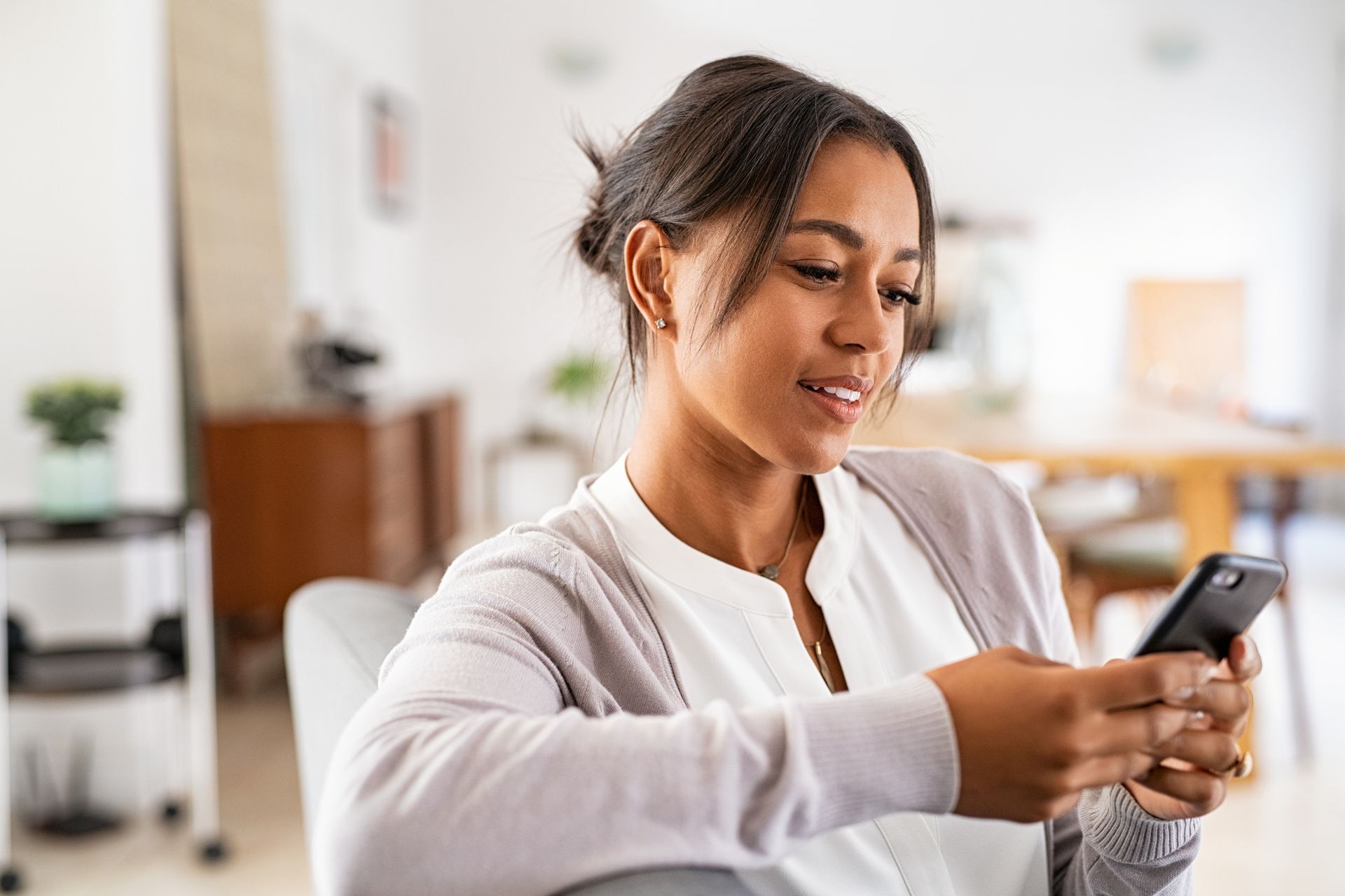 a woman looking at her cell phone