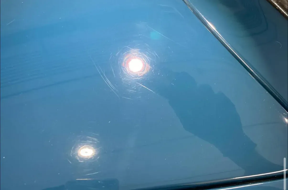 Paint with defects, swirls, and scratches. 
