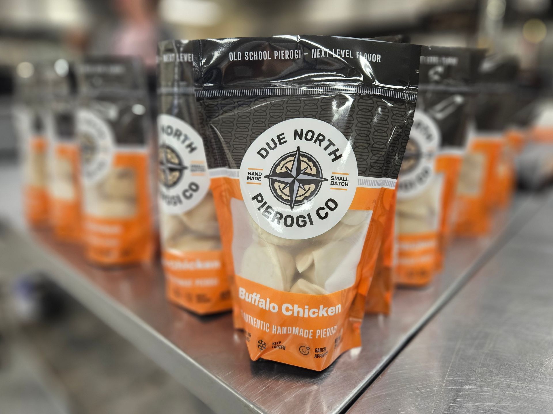 Duke’s North Dog Co. deli chicken treat bag on a store shelf with more bags blurred behind it