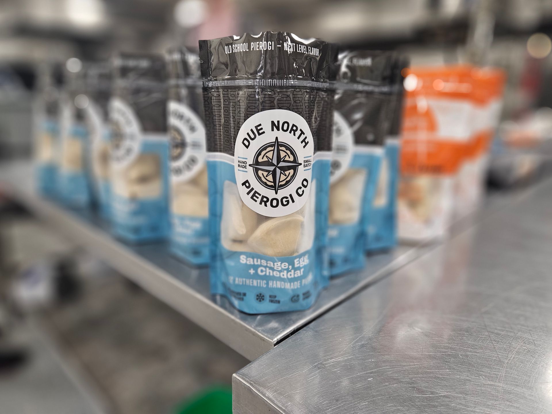 Blue “Die Nord” coffee bags on a store shelf, with other packages blurred in the background.