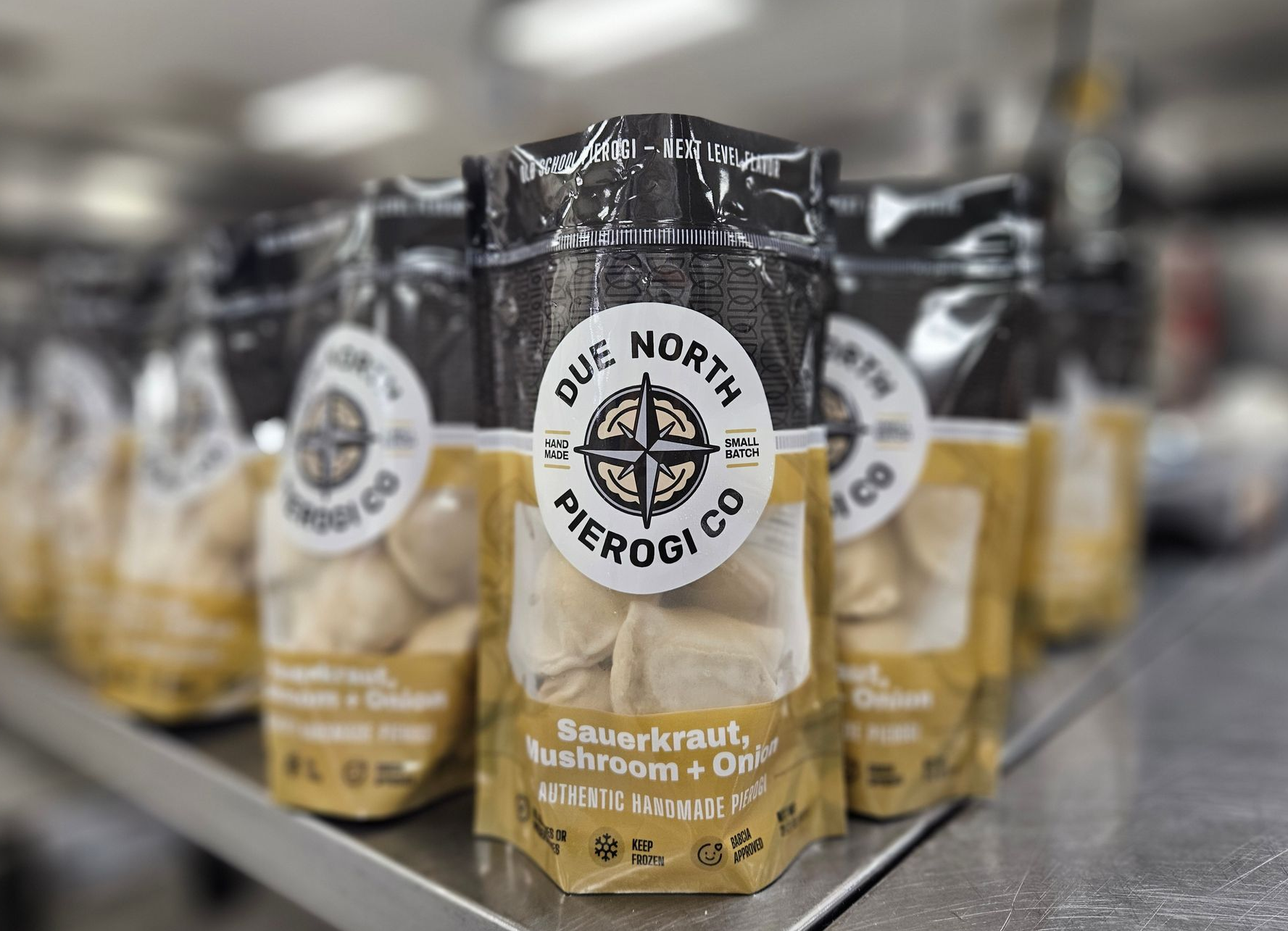 Bags of Due North Pierogi Co. sauerkraut, mushroom & onion pierogies on a store shelf