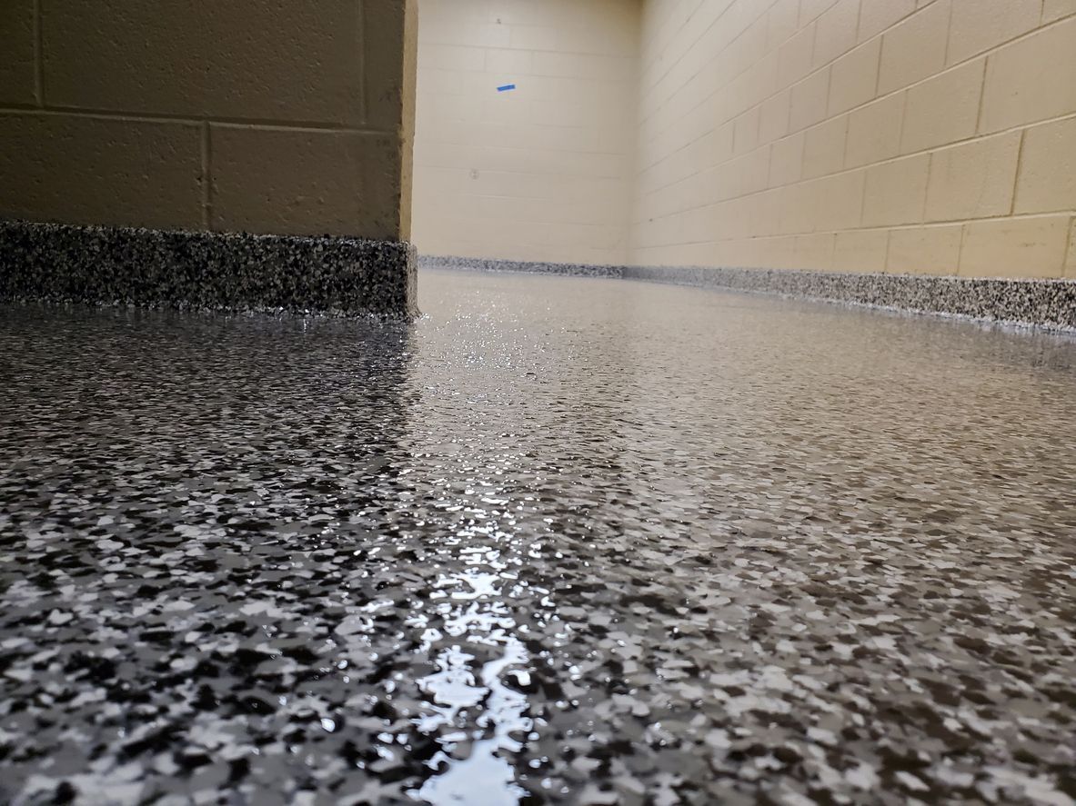 Empty hallway with a glossy speckled floor and beige walls