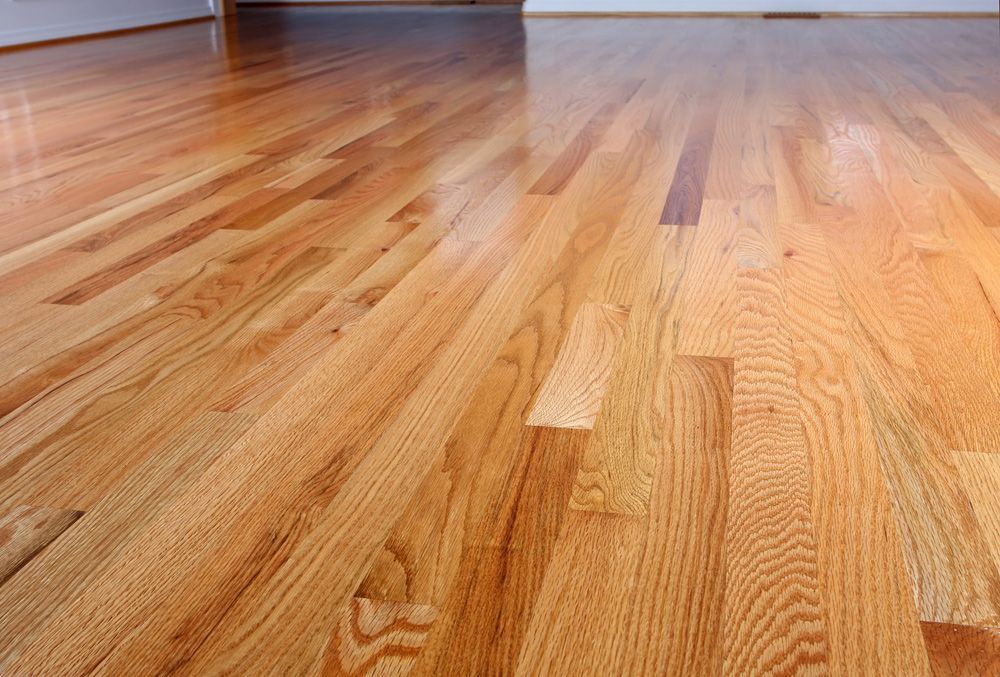 A close up of a wooden floor in an empty room.