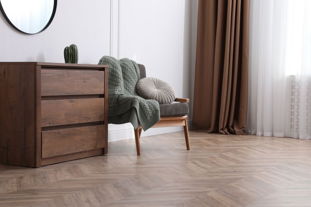 There is a chair and a dresser in the room.