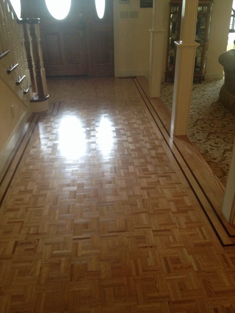 A hallway with a wooden floor and stairs