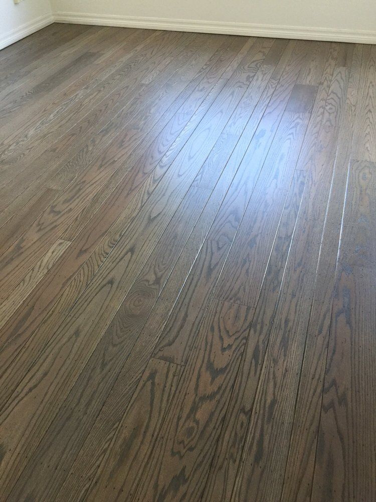 A room with a wooden floor and white walls.