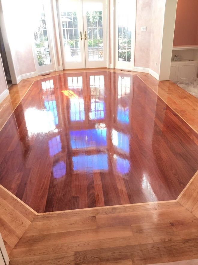 A living room with a wooden floor and sliding glass doors