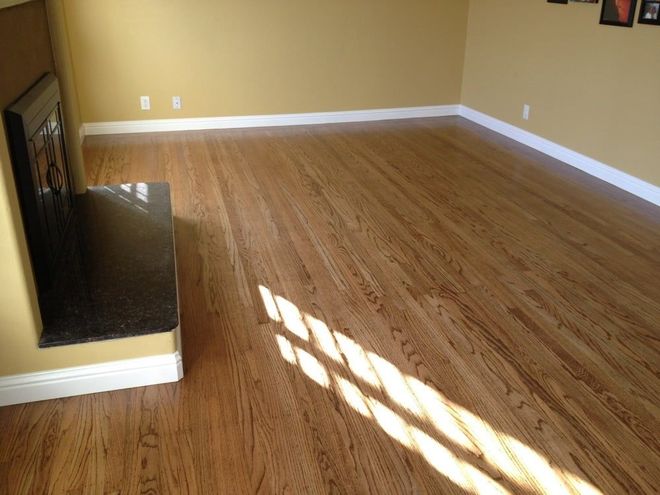 A living room with hardwood floors and a fireplace