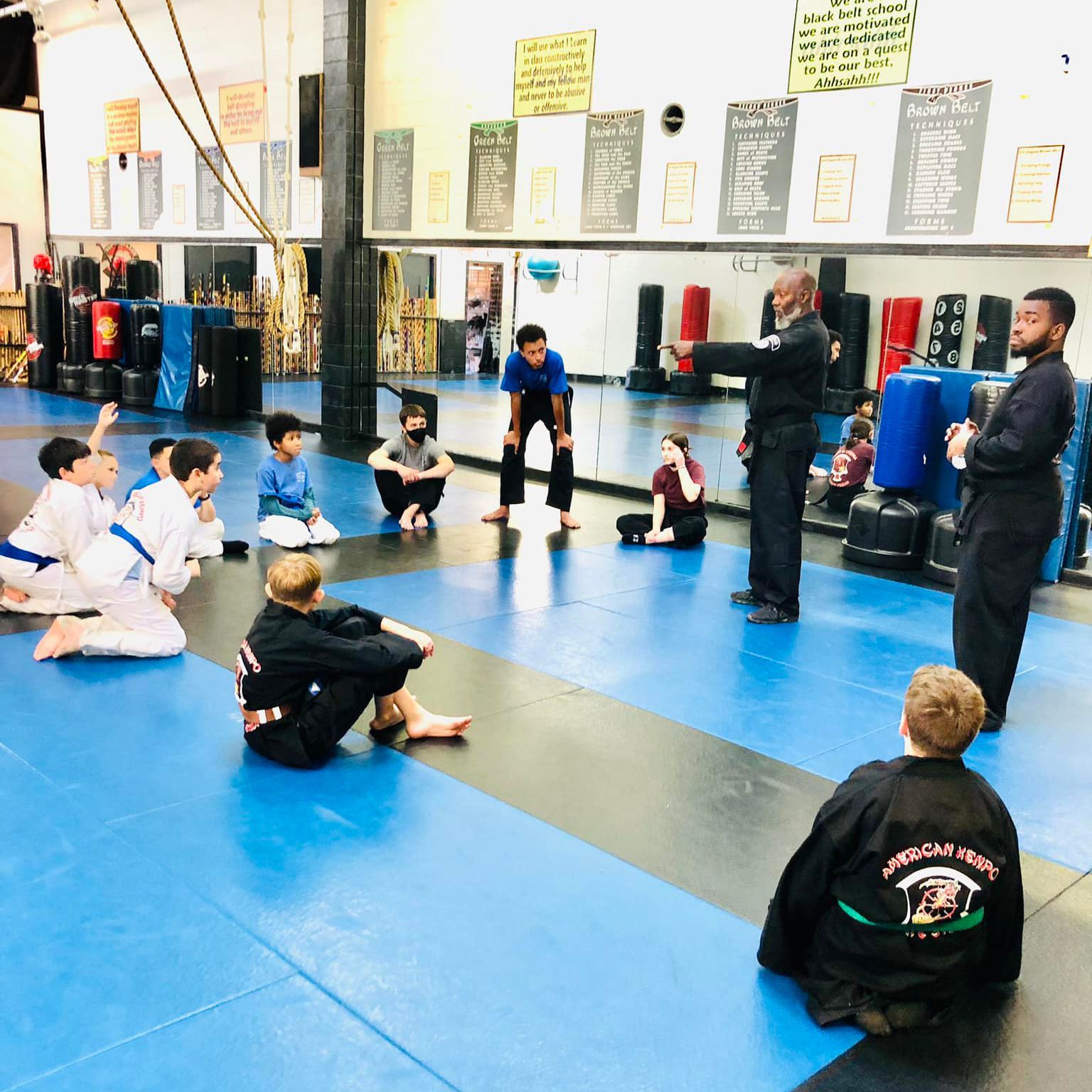 Young children in uniform sparring during martial arts session