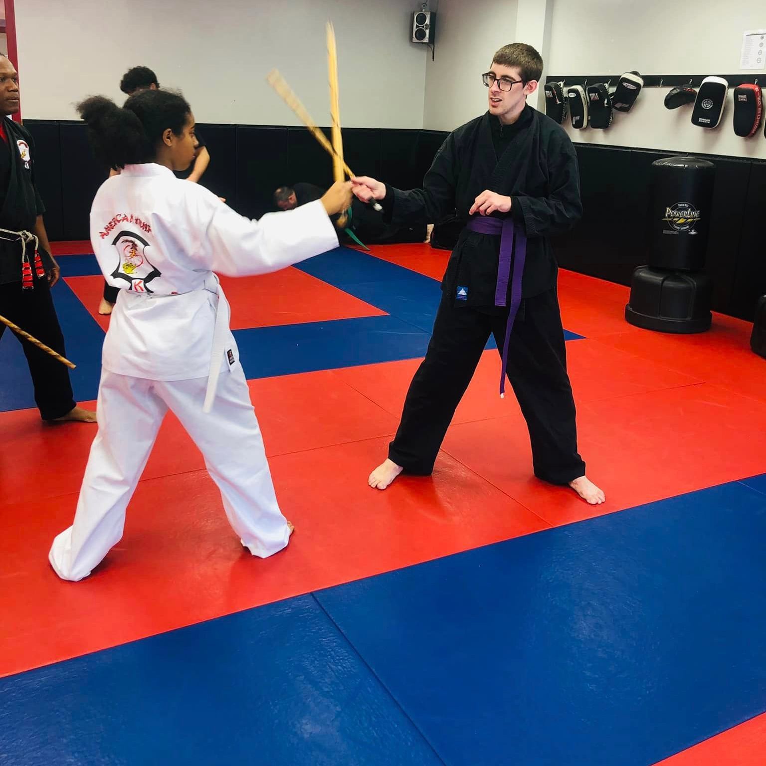 a girl wearing a karate uniform with the word karate on it
