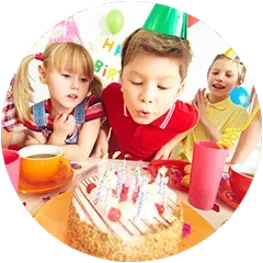 a group of children are sitting at a table with a birthday cake .