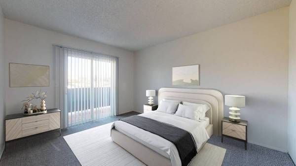 Bright modern bedroom with a white bed, bedside lamps, dresser, and sliding glass door to a balcony