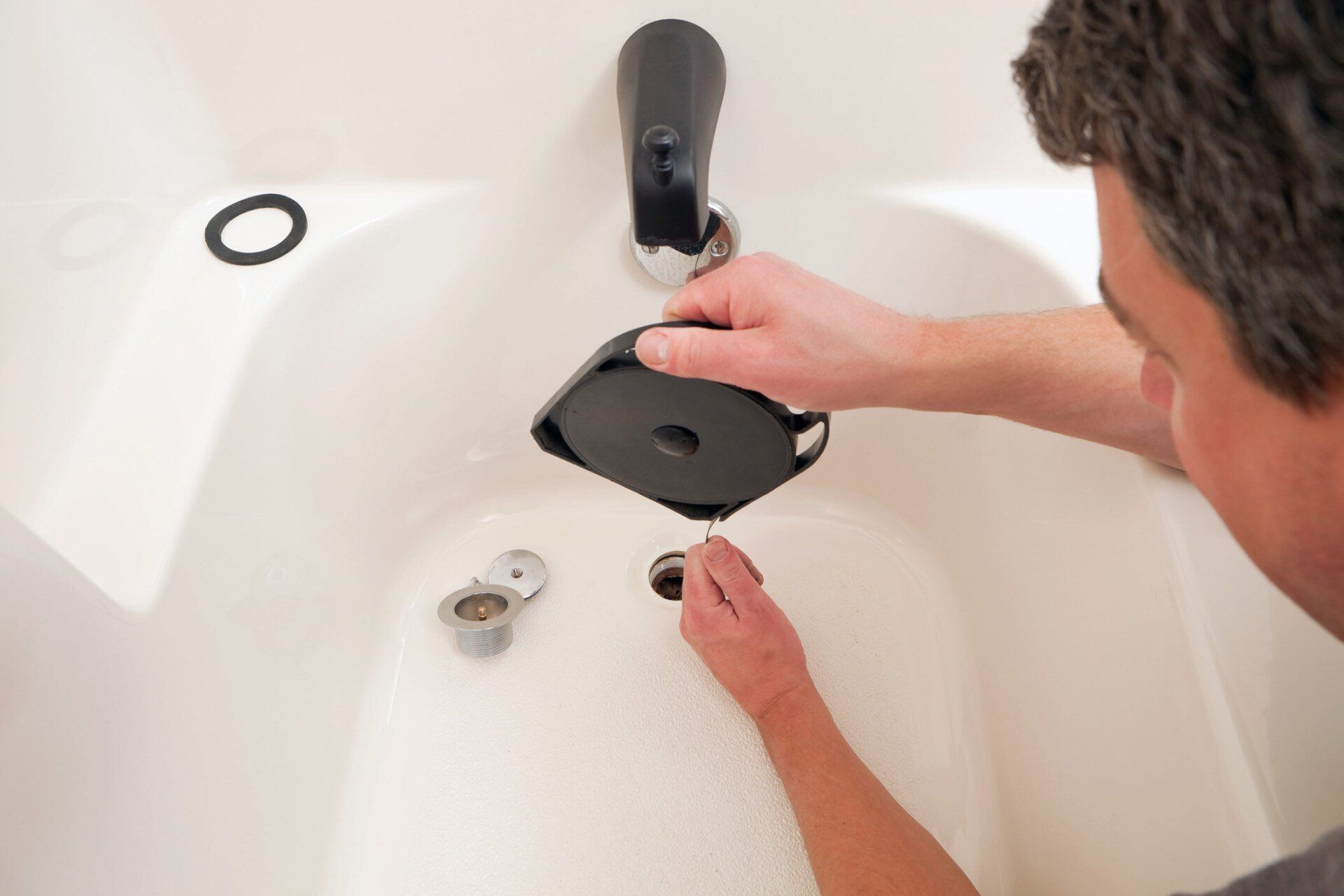 Plumber Using Spiral Pipe Cleaning Rod — Statesville, NC — Drain Doctor