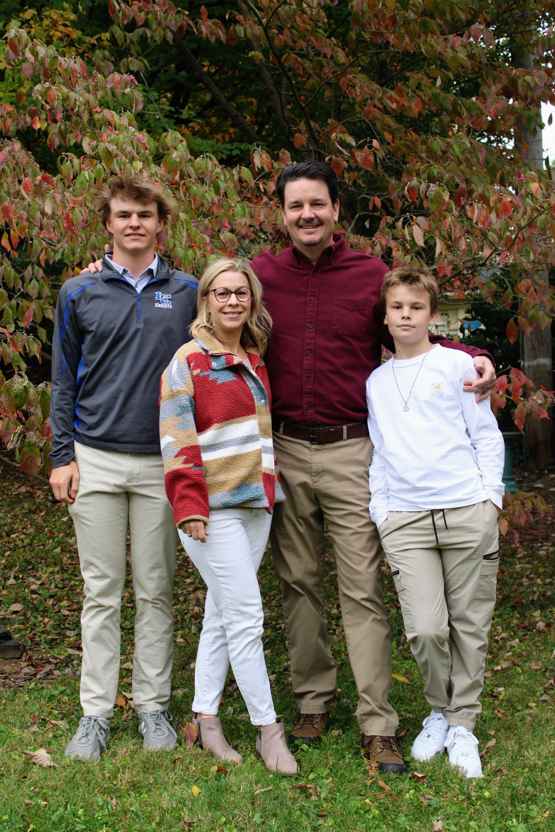 Spiller family is posing for a picture in the grass.