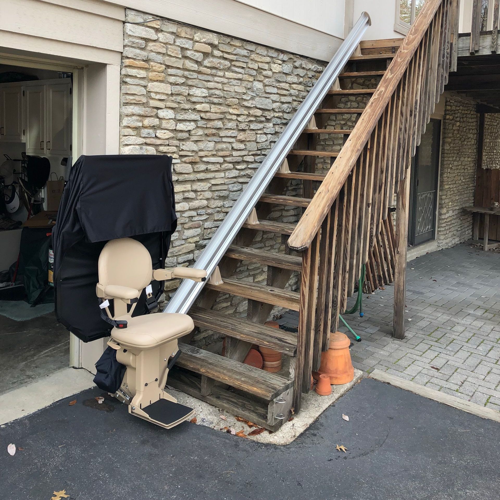 A stair lift is sitting next to a set of stairs