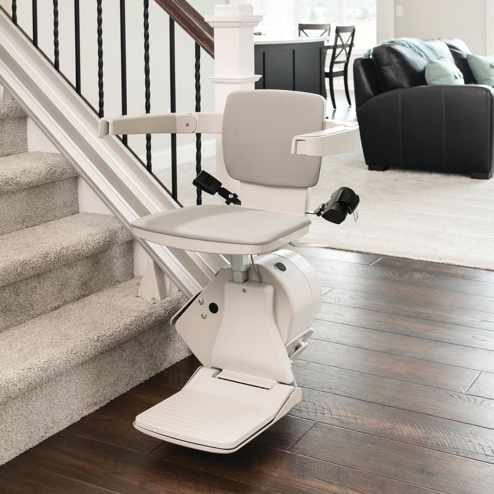A white chair is sitting on the stairs in a living room