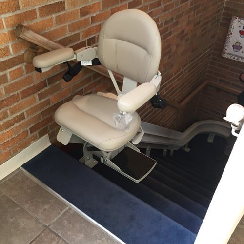 A chair is sitting on top of a set of stairs.