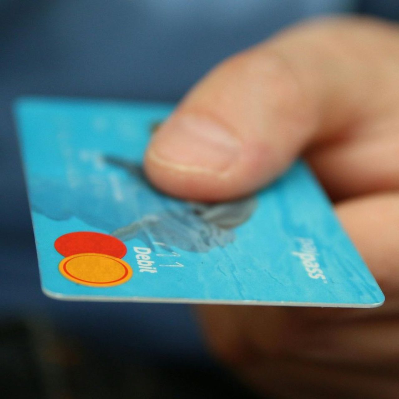 A person is holding a credit card in their hand.
