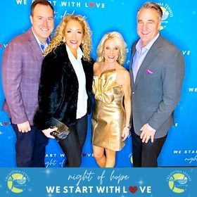 Four adults posing on a blue “Night of Hope” step-and-repeat backdrop, smiling at an event.