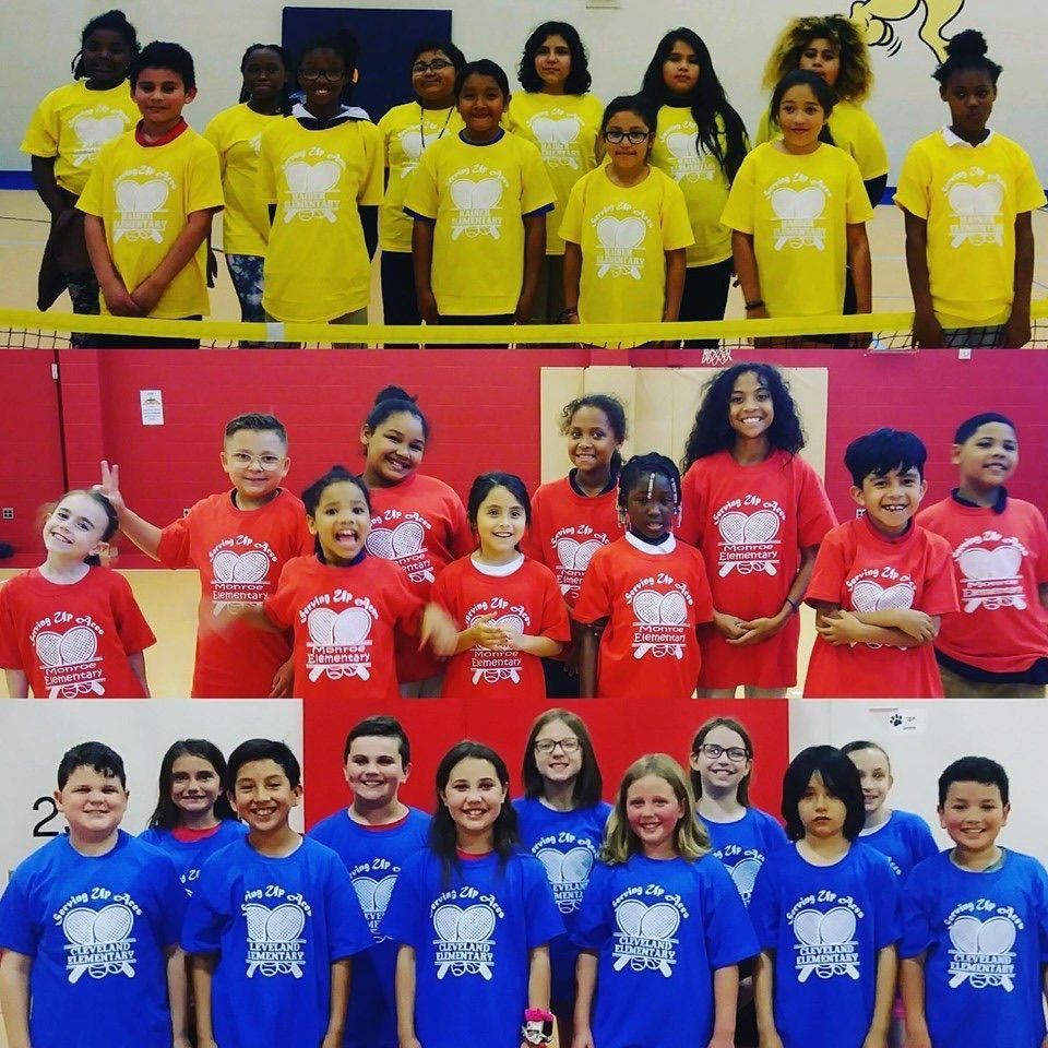 Three rows of children in matching yellow, red, and blue T-shirts pose indoors.