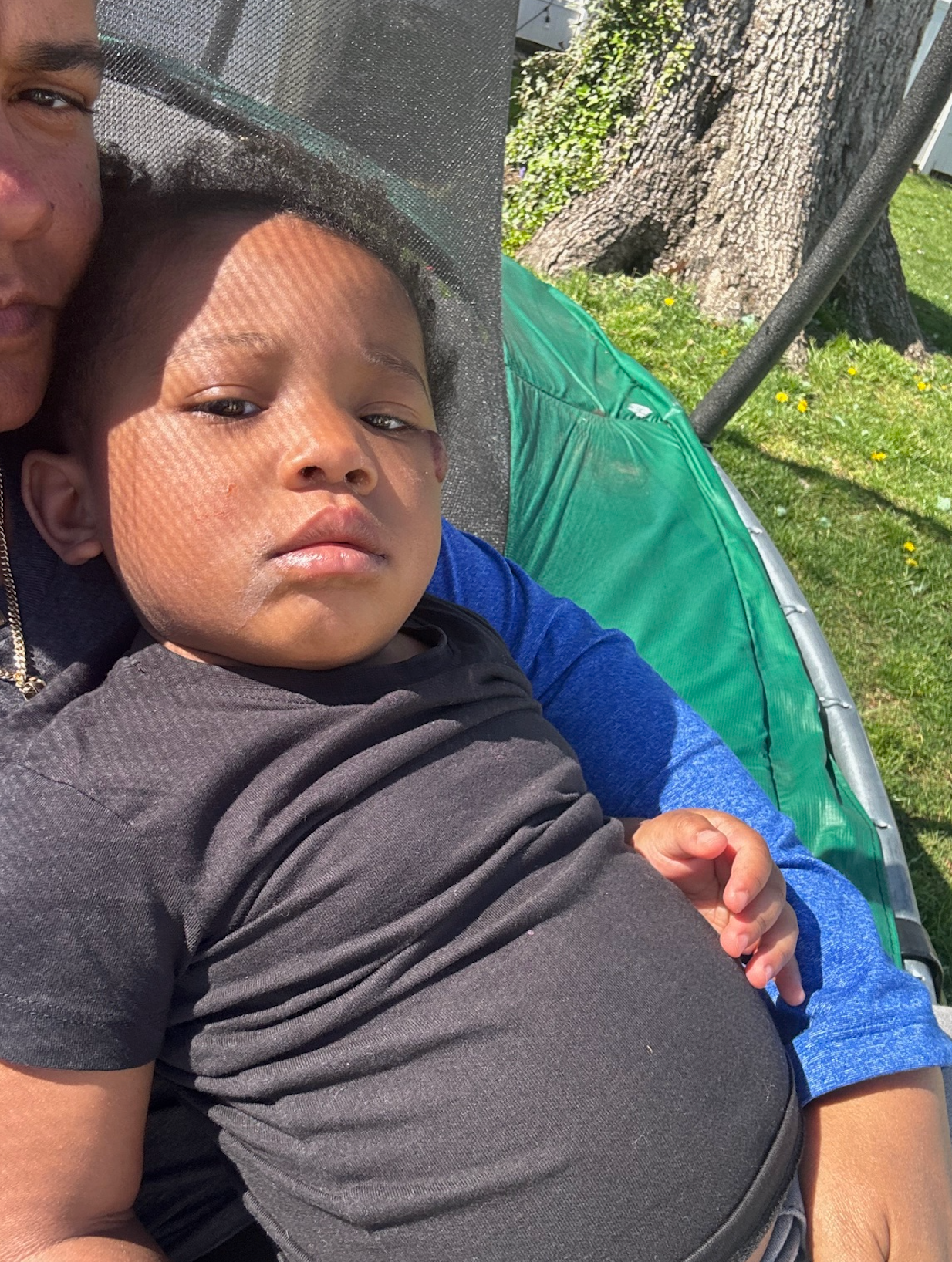 A woman is holding a little boy in her arms.