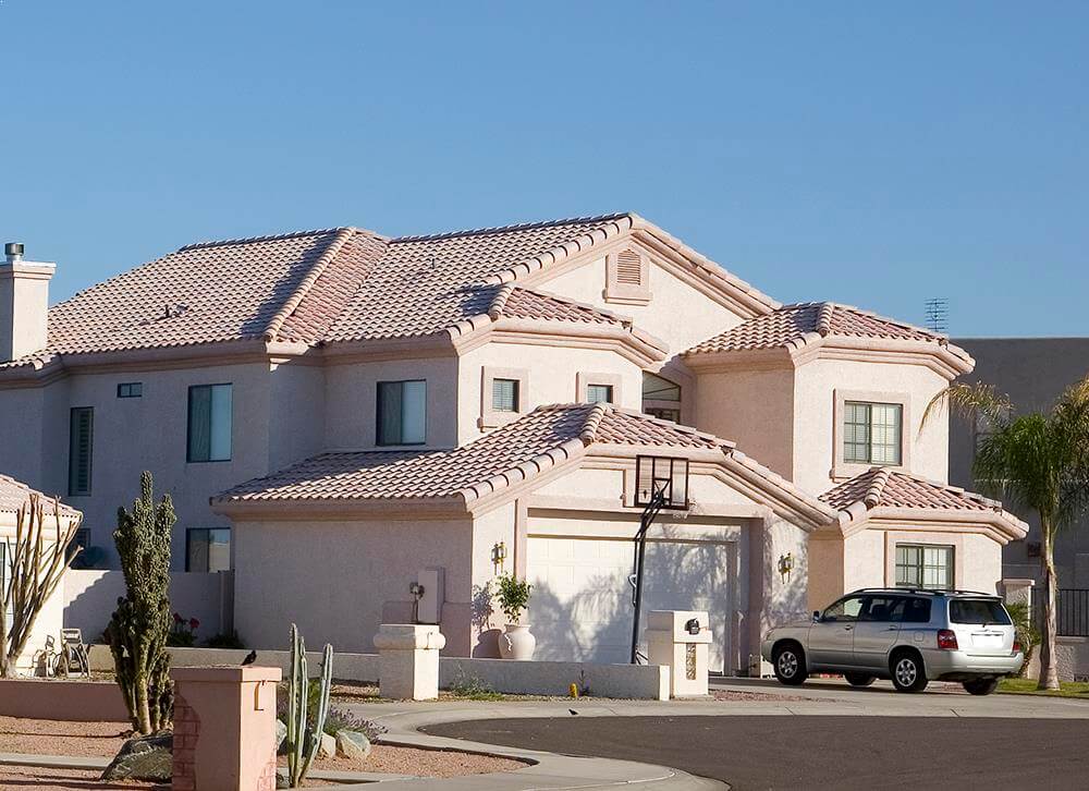 A large white house with a car parked in front of it