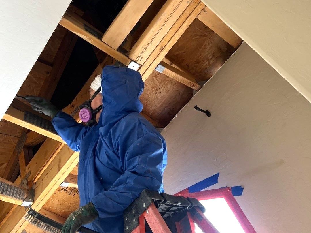 A mold remediation technician testing the air quality of a home