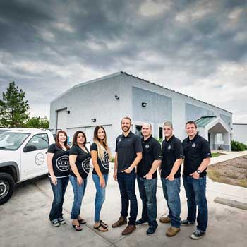 A group of people are posing for a picture in front of a building.
