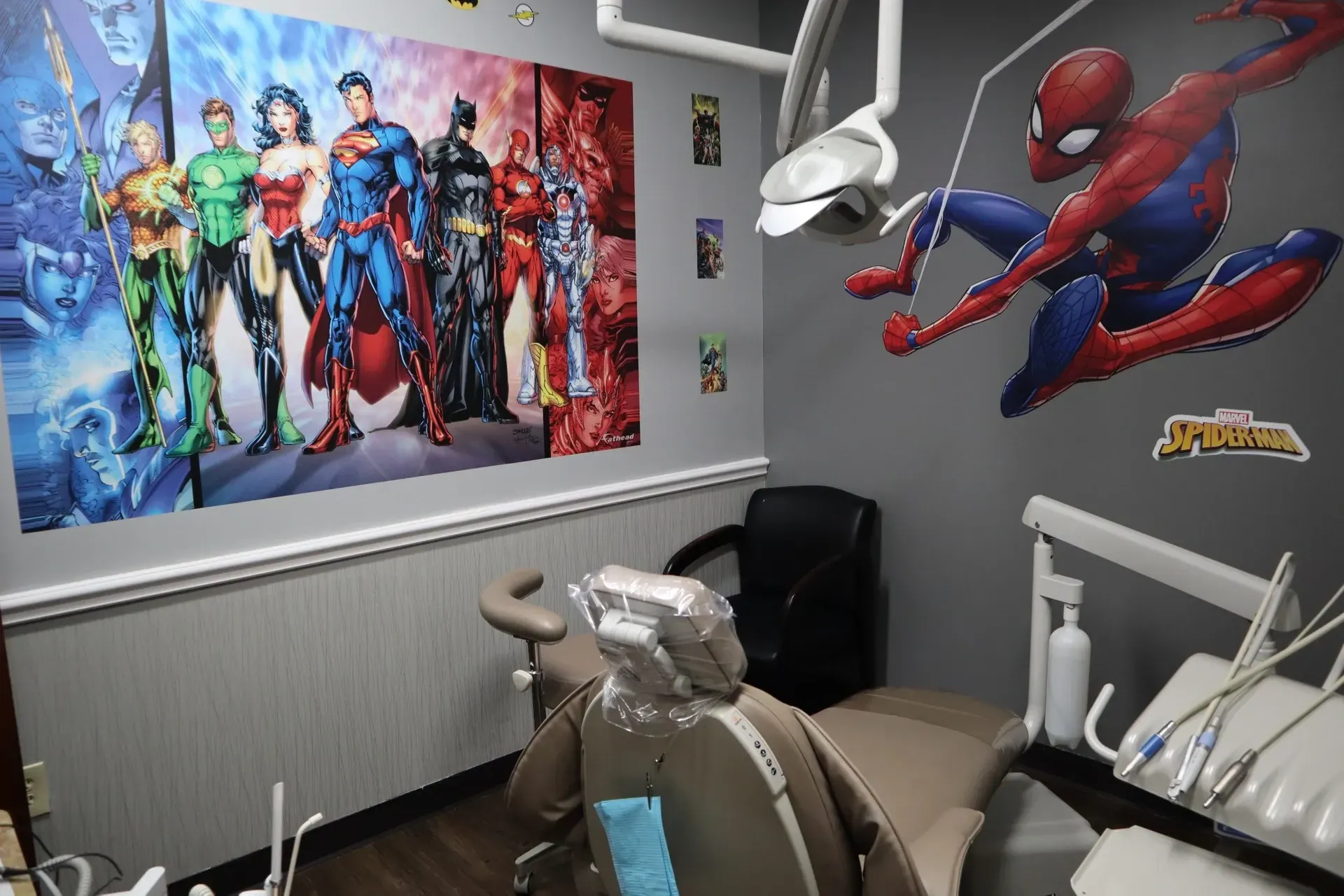 Luna-Dental-Dallas- A superhero-themed dentist's office with comic characters on walls and a dental chair.