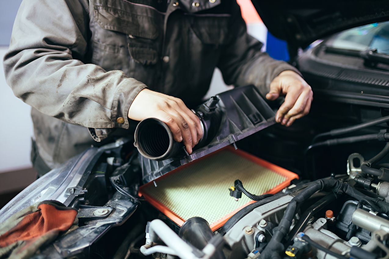 A Man is Working on the Air Filter of a Car — Auto Blue Service Centre In Bungalow, QLD
