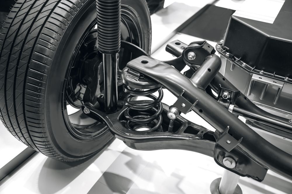 A Close Up of a Car Suspension With a Tire in the Background — Auto Blue Service Centre In Bungalow, QLD