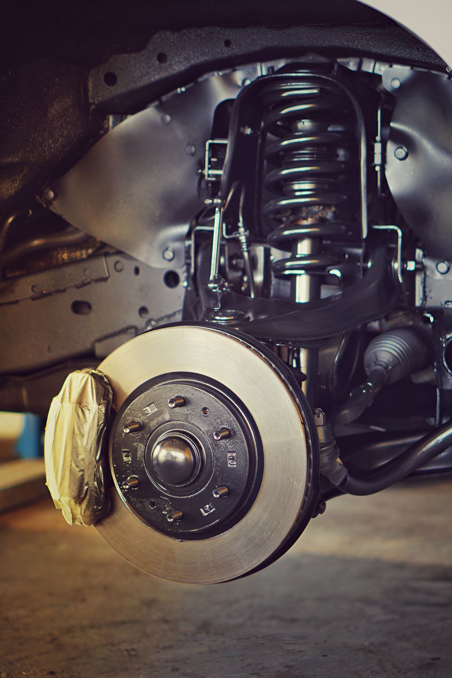 A Close Up of a Car 's Suspension and Brake System — Auto Blue Service Centre In Bungalow, QLD
