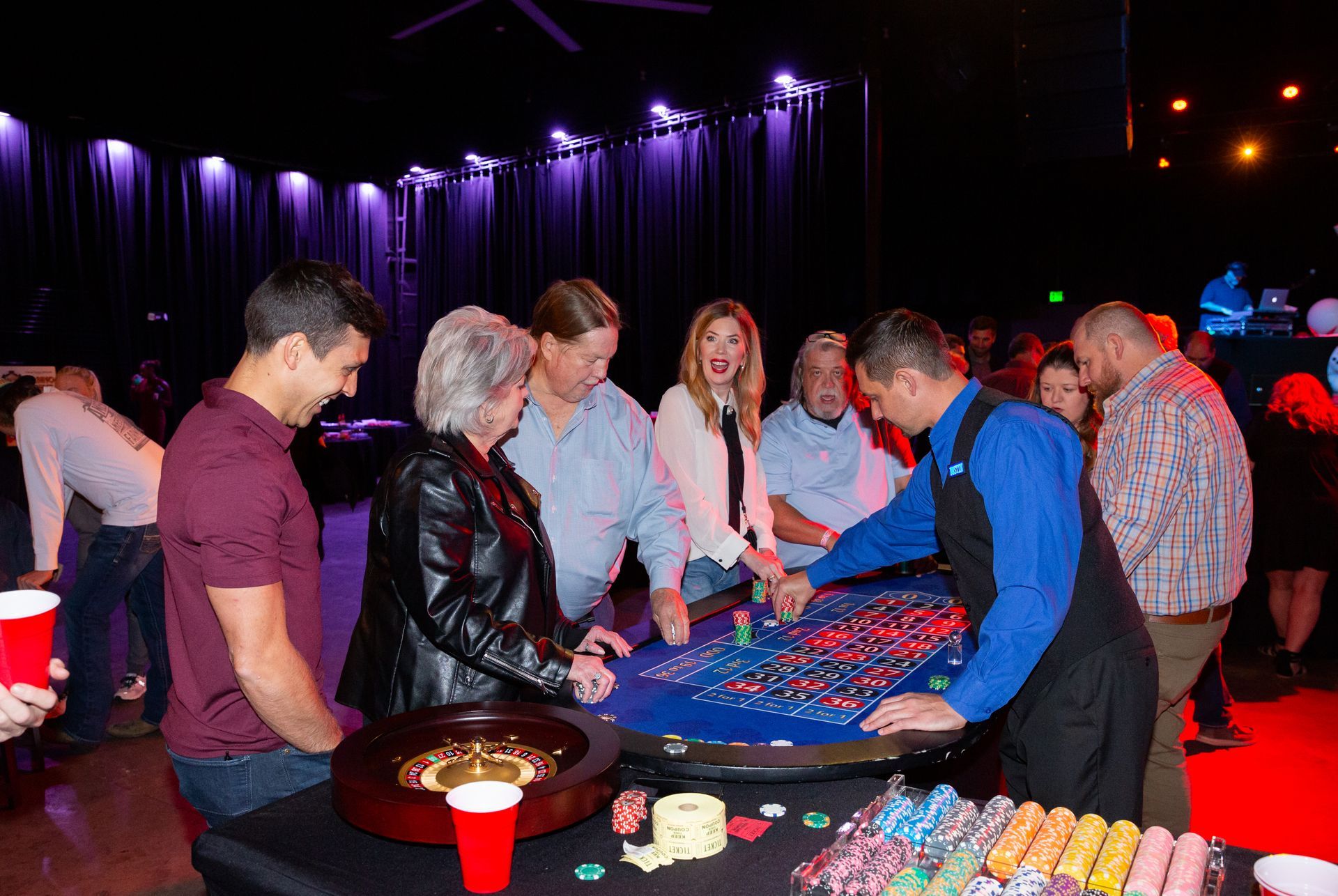 A group of people are playing roulette in a casino.