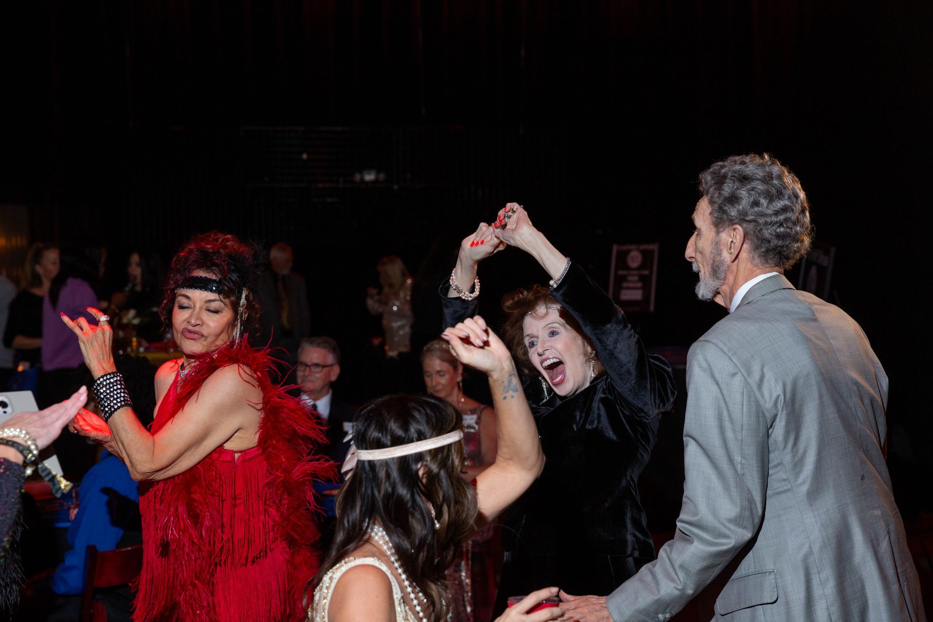 A group of people are dancing together at a party.