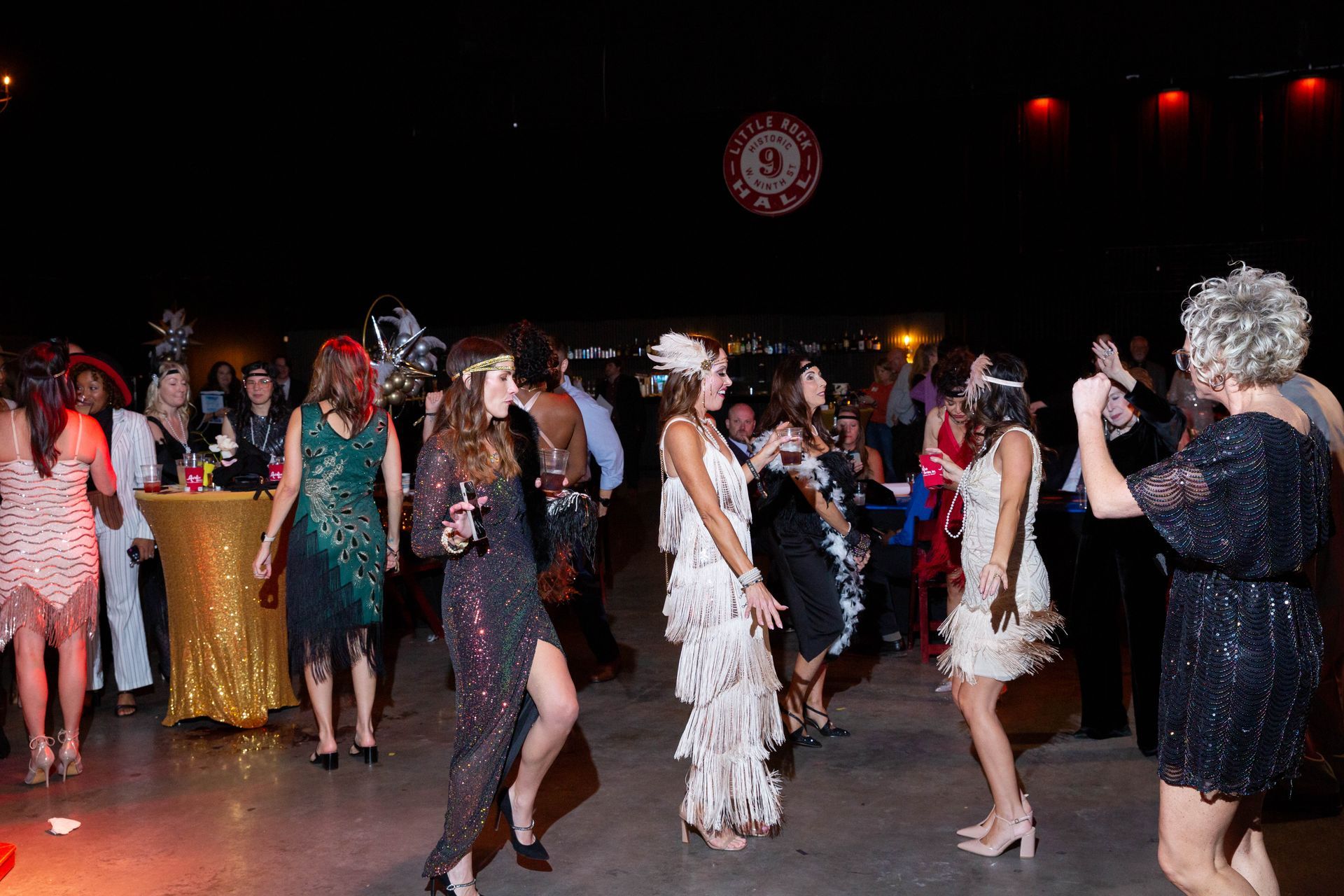 A group of women are dancing on a dance floor at a party.