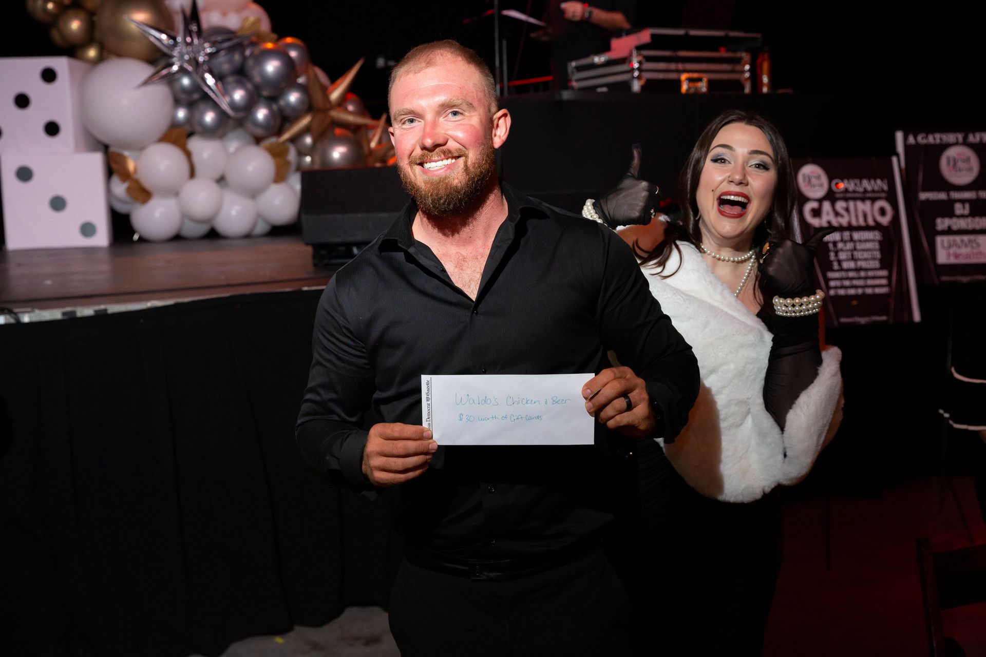 A man is holding a piece of paper in front of a woman.
