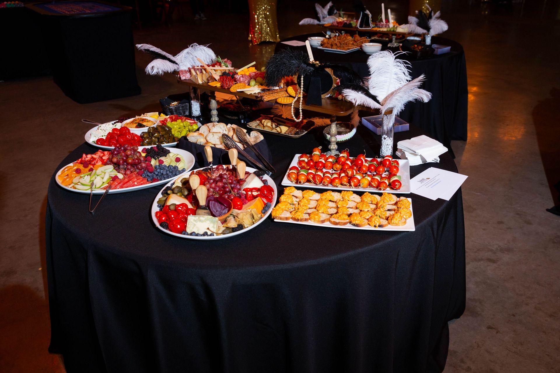 A table with plates of food and feathers on it