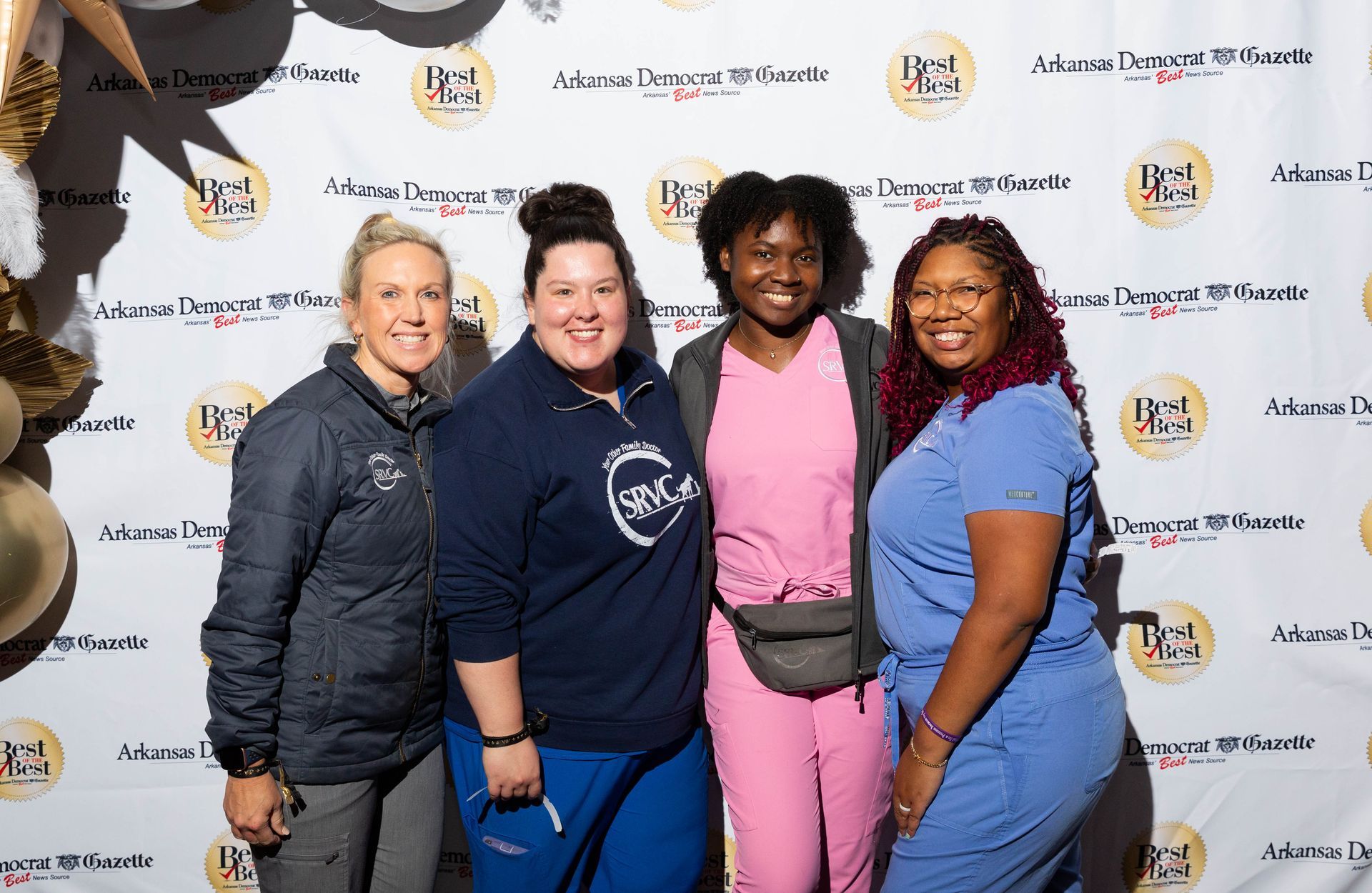A group of women in scrubs are posing for a picture.
