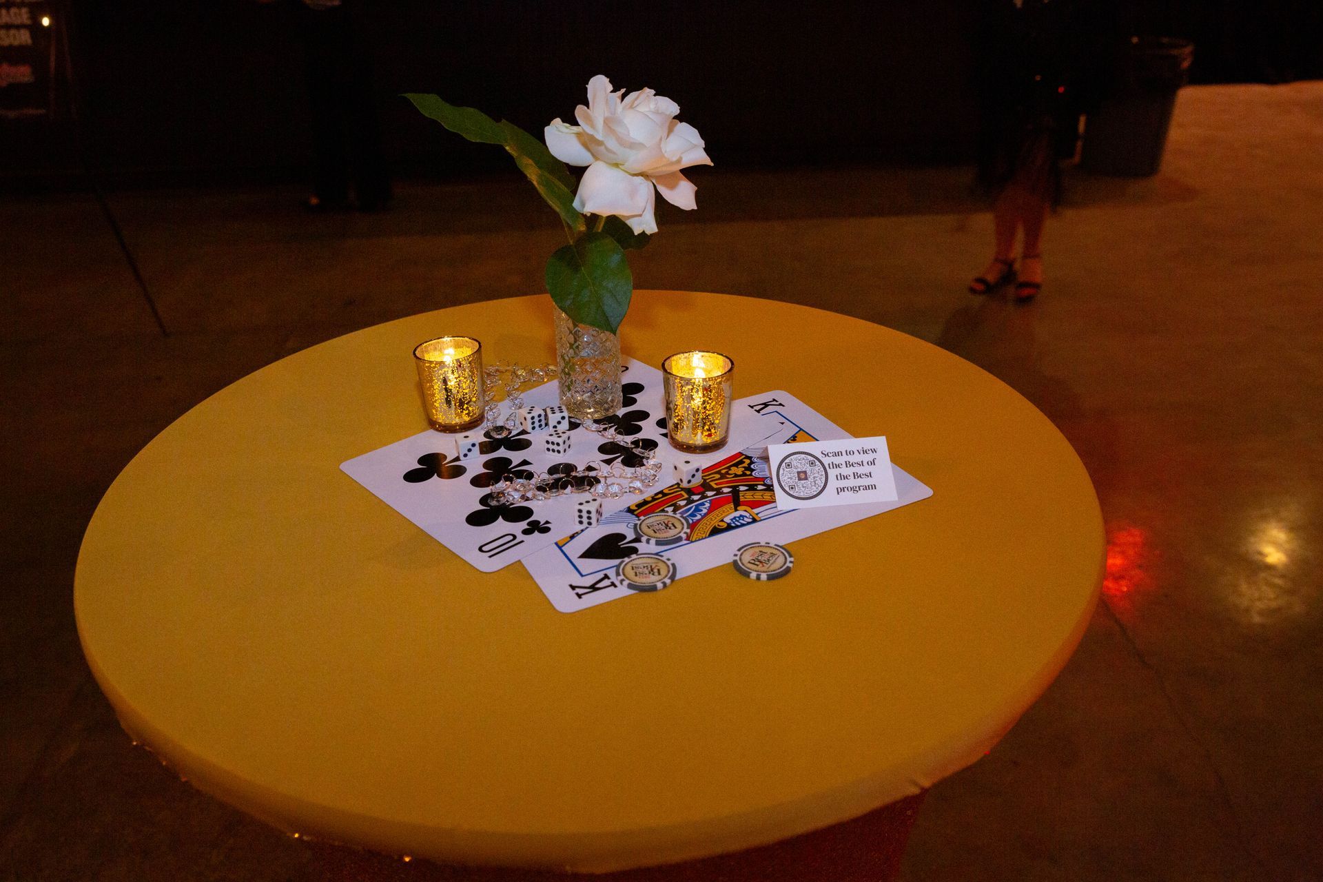A table with a flower and candles on it
