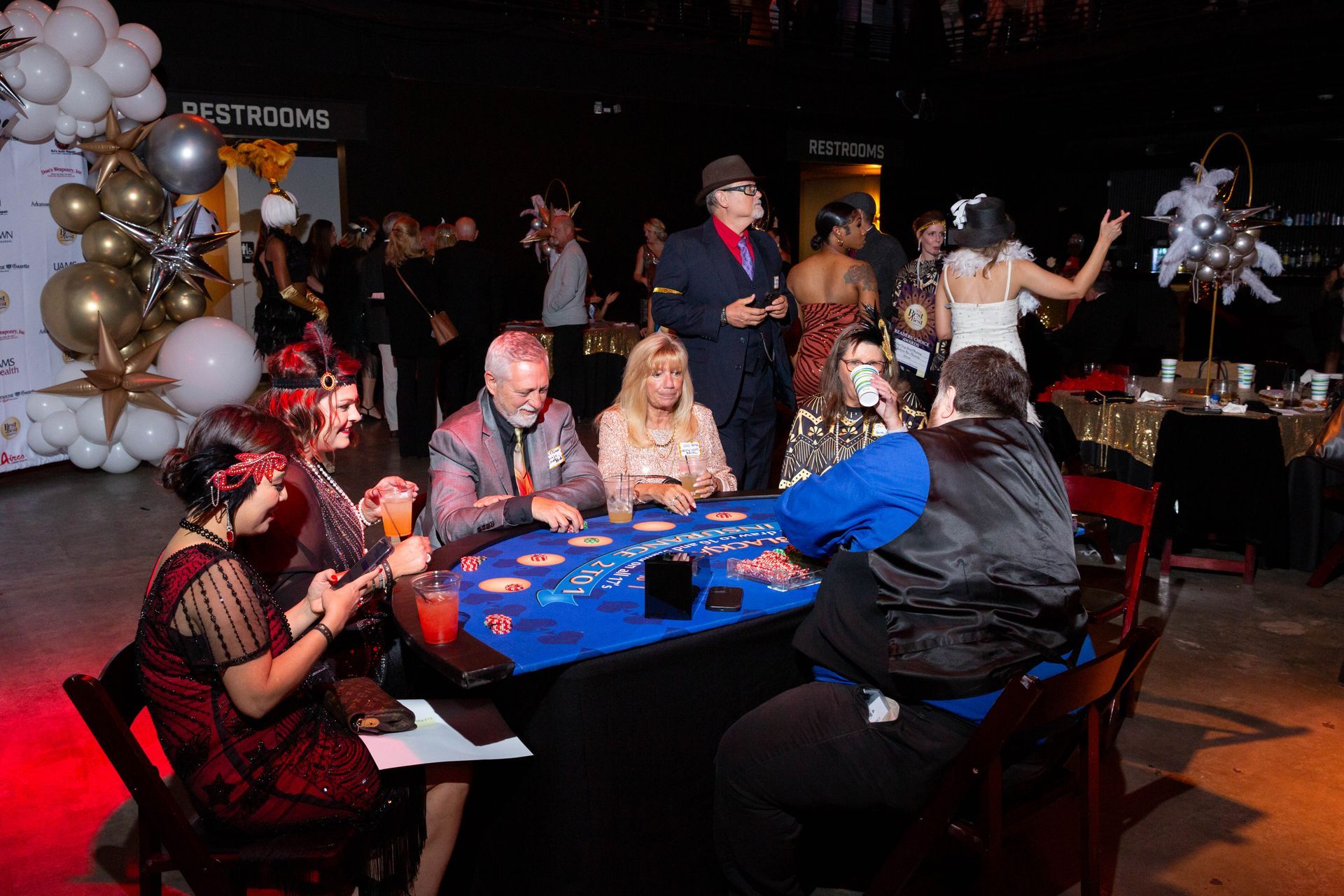 A group of people are sitting around a table playing poker.