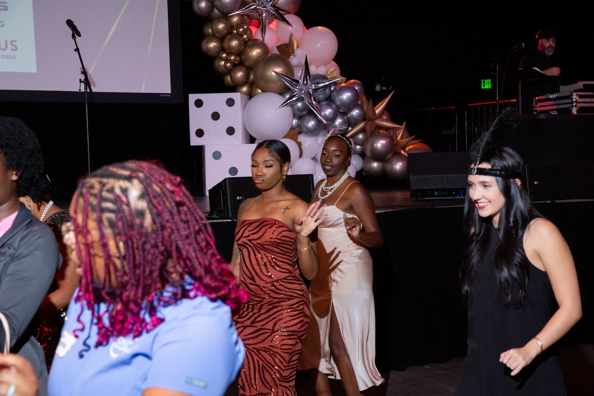 A group of women are dancing at a party.