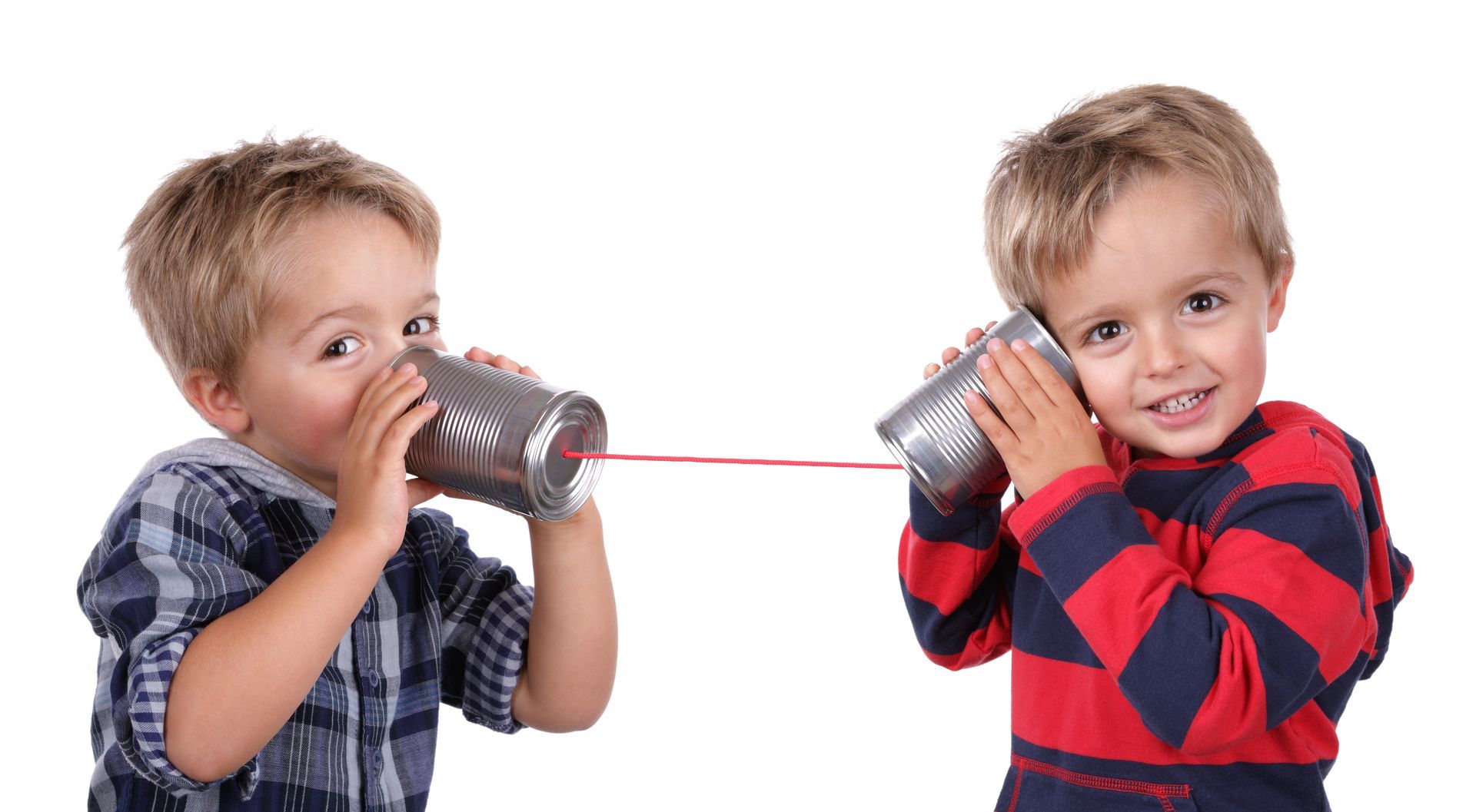 Two boys are playing telephone with tin cans