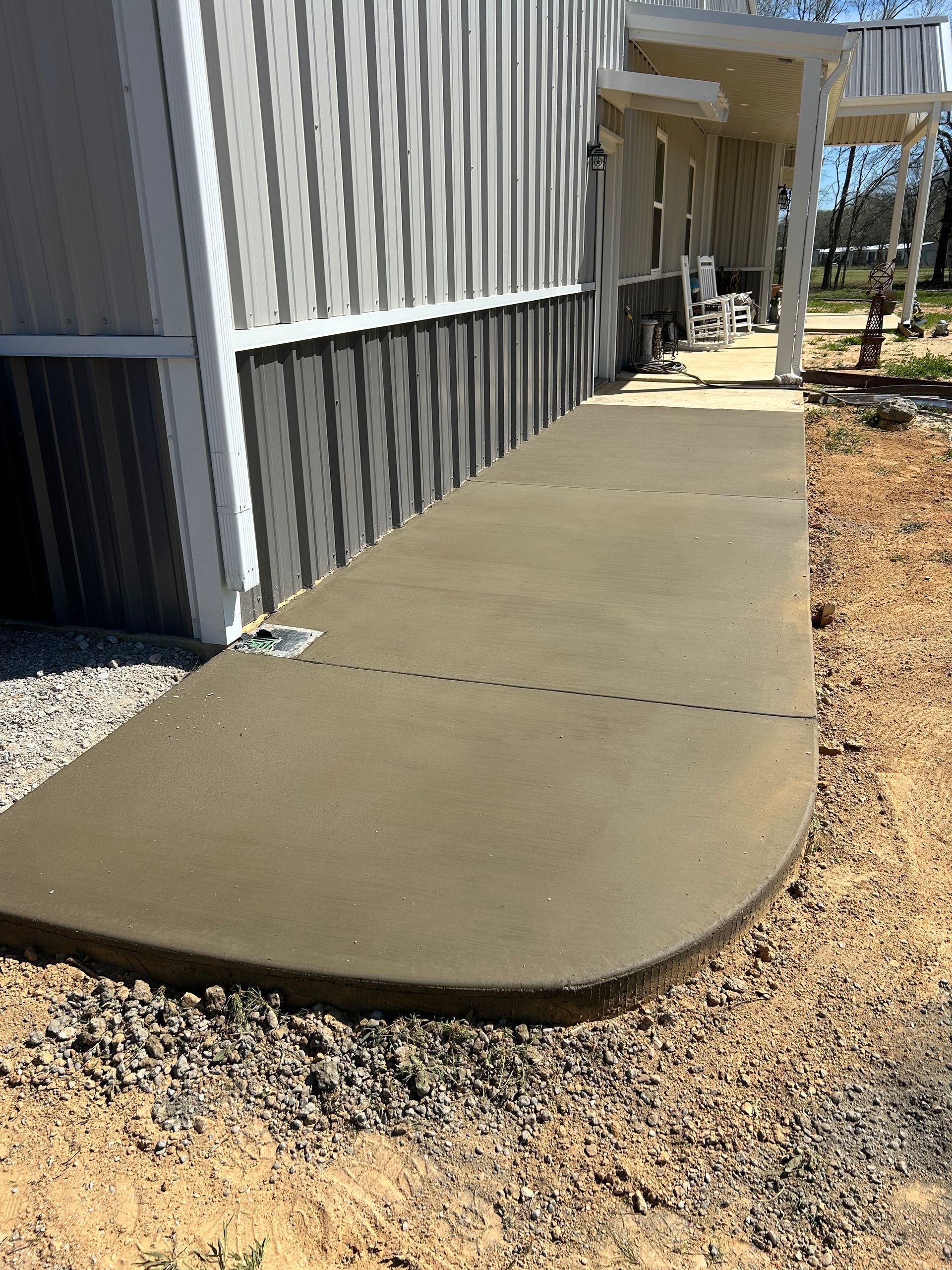 A concrete walkway is being built in front of a house.