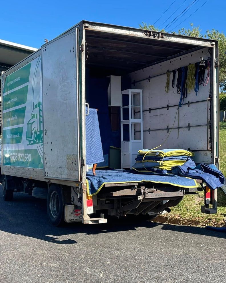 A Moving Truck Is Parked On The Side Of The Road With The Back Door Open — Easy Flow Removals In Bonny Hills, NSW