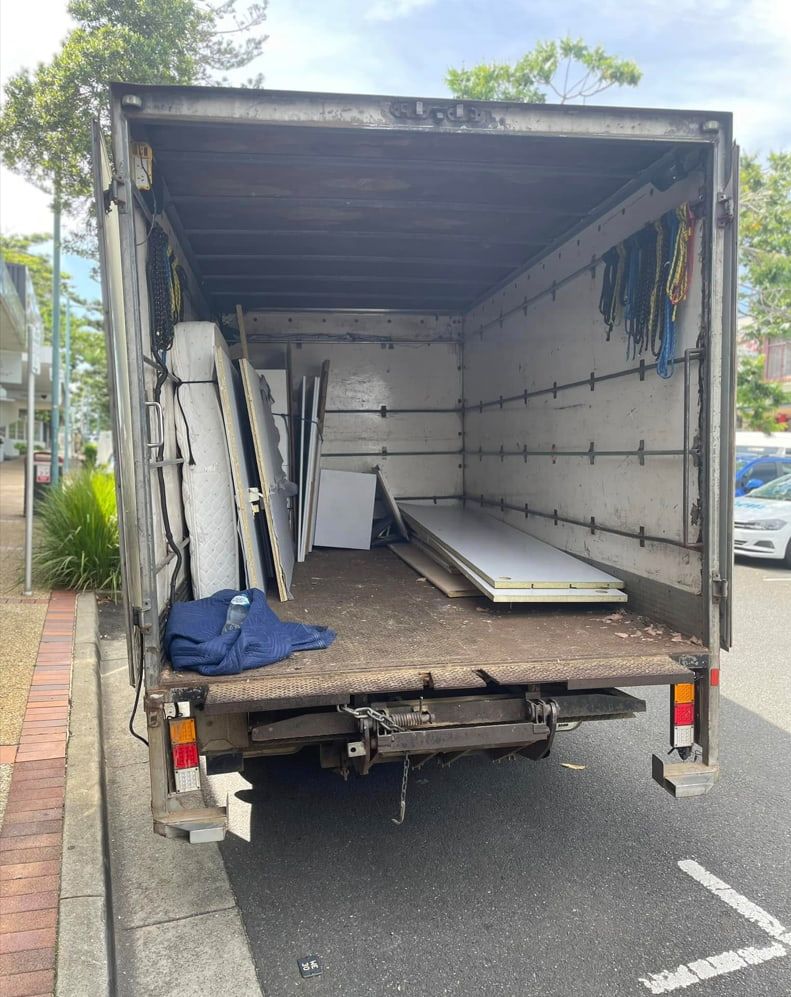A Removalist Truck Is Parked On The Side Of The Road With The Back Door Open — Easy Flow Removals In Laurieton, NSW