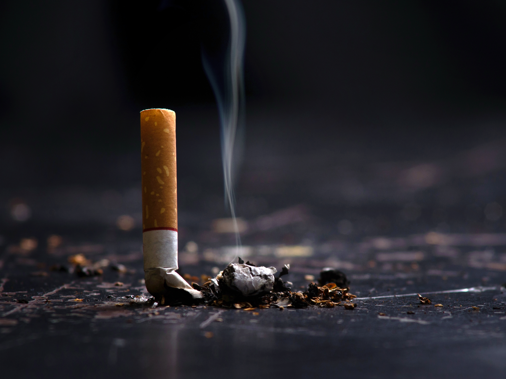 Close-up of a burning cigarette, emphasizing cigarette smoke removal.