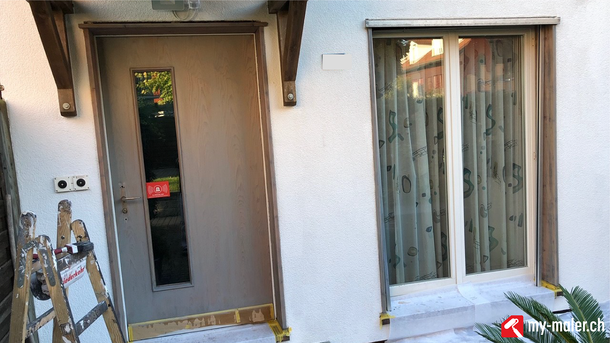 Ein weisses Haus mit einer Tür und einem Fenster