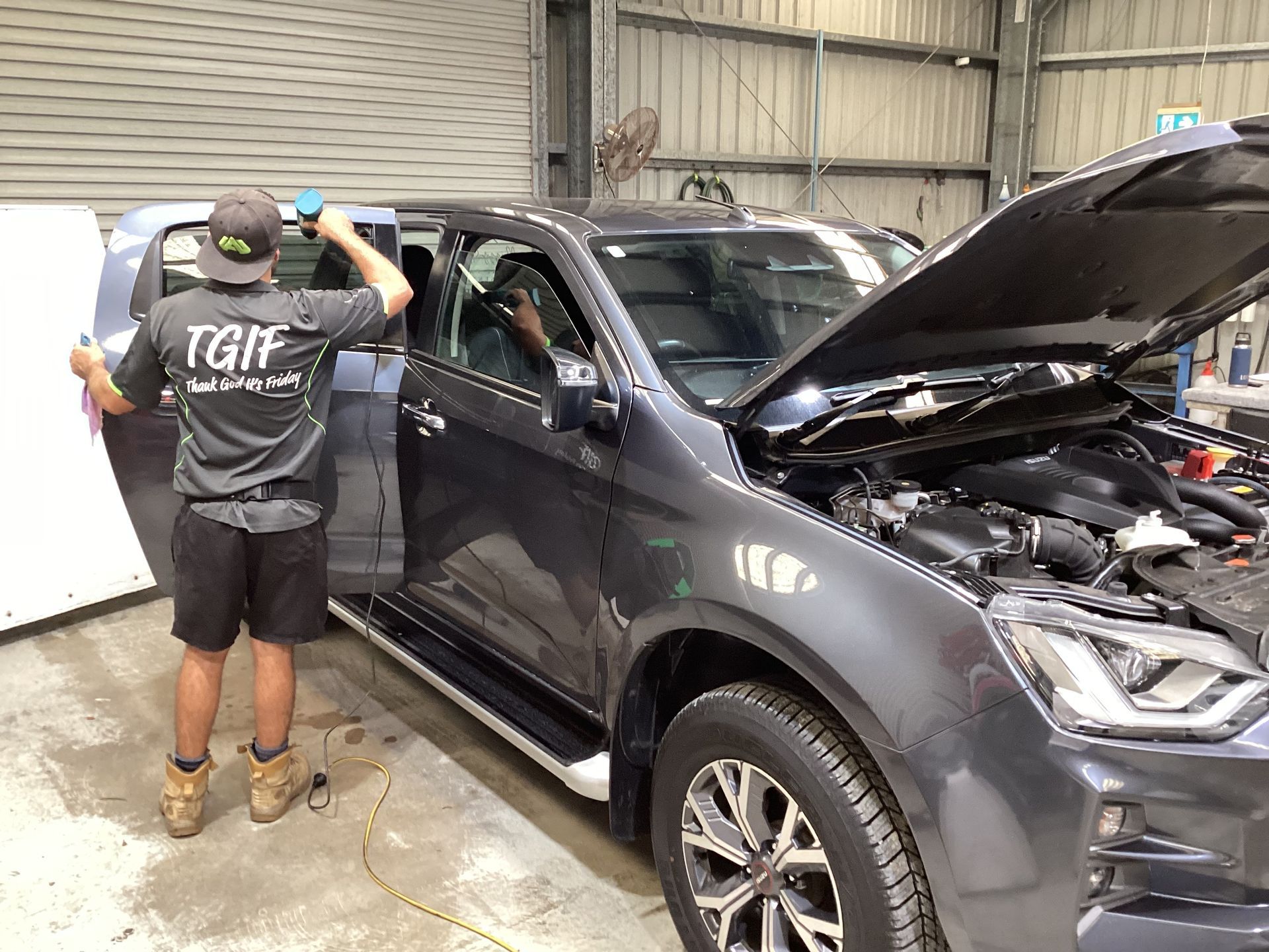A Person Is Tinting Glass On A Car With A Heat Gun— Advanced Windscreens & Service Centre In Proserpine, QLD