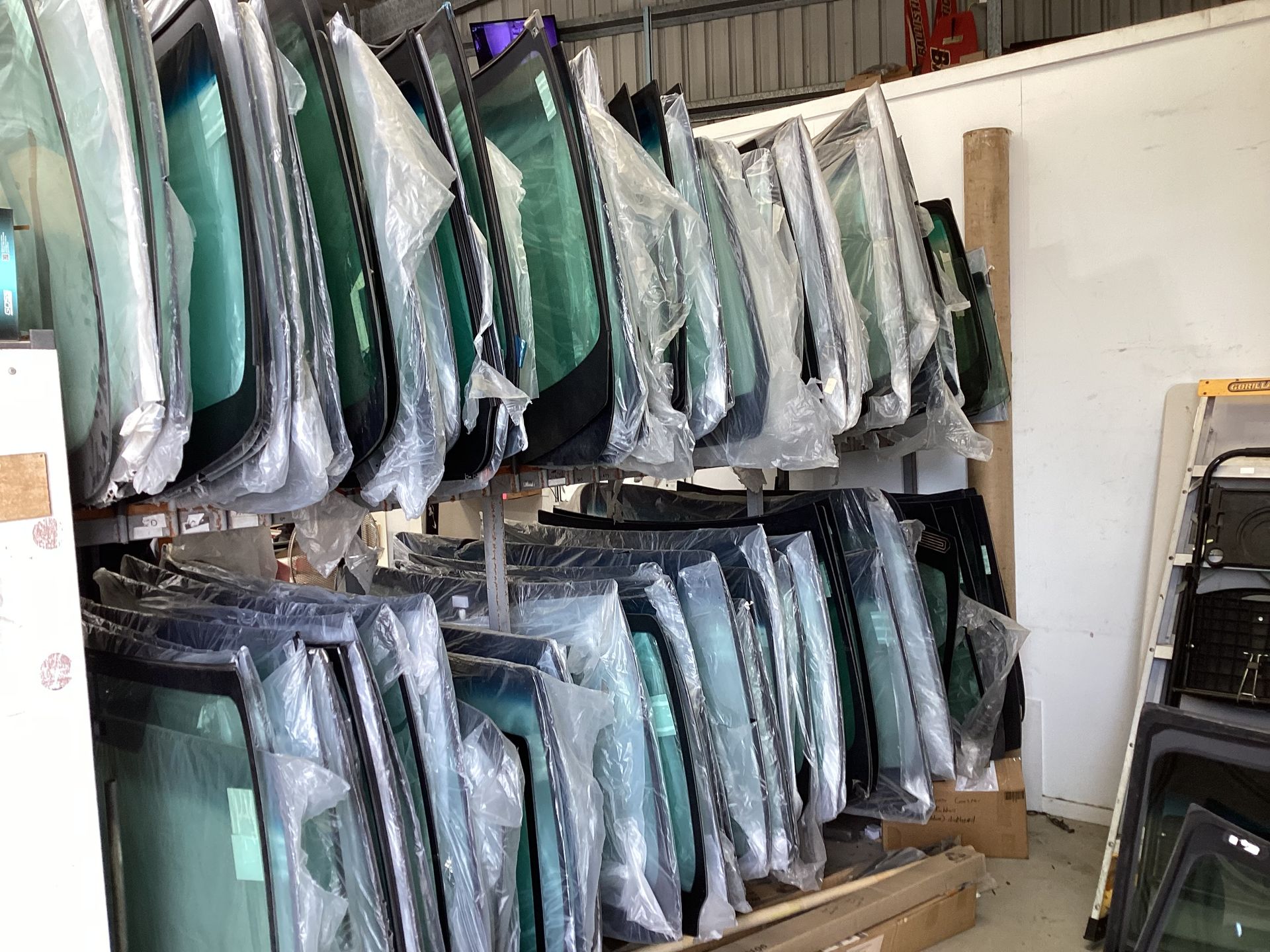 Rows Of Windscreens In A Garage — Advanced Windscreens & Service Centre In Proserpine, QLD