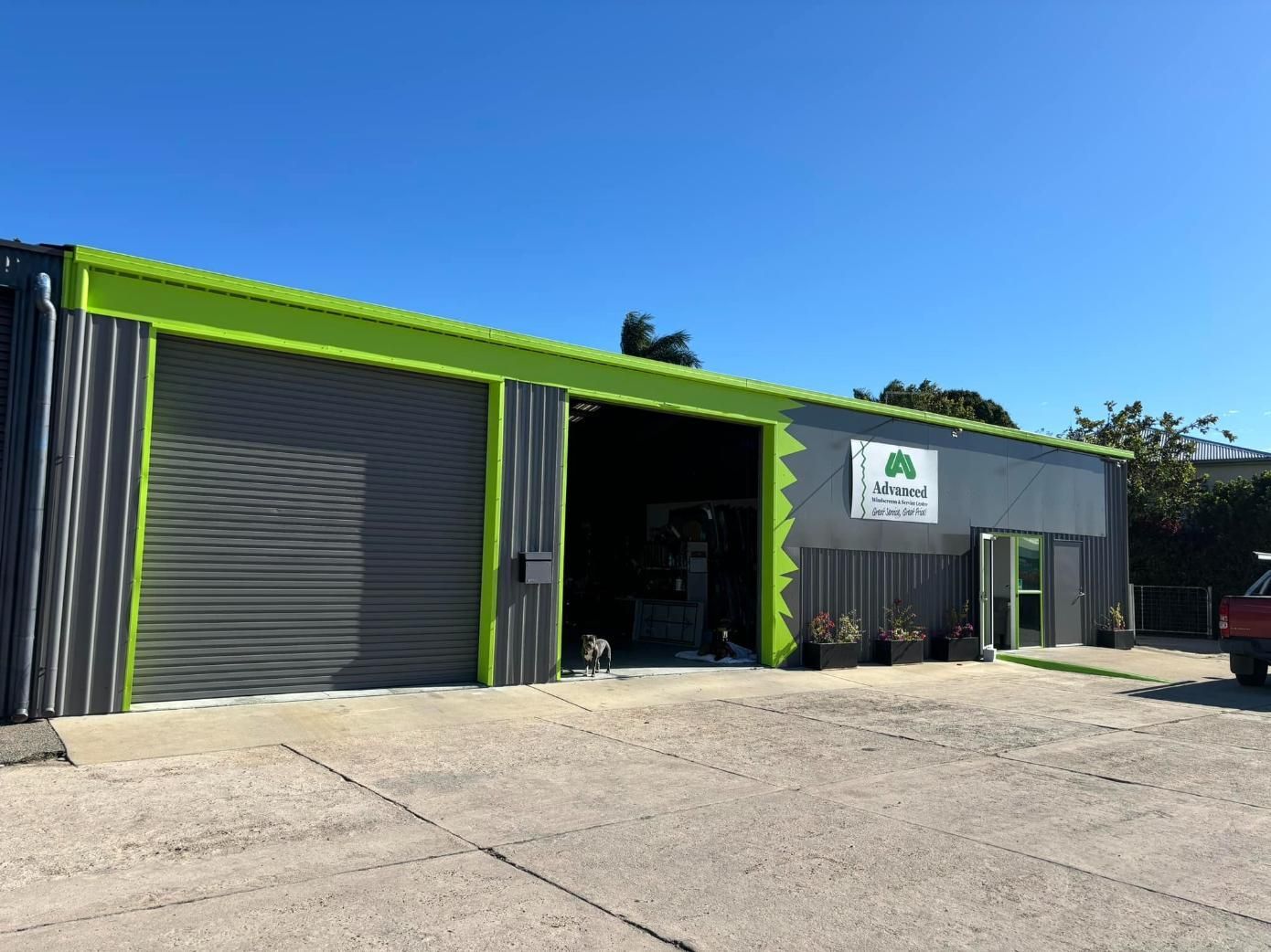 A Green And Gray Building — Advanced Windscreens & Service Centre In Proserpine, QLD